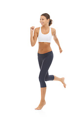 Image showing Woman, smile and running exercise in studio for cardio fitness or training athlete for lose weight, mockup or white background. Female person, jog and sports workout for healthy body, gym or wellness