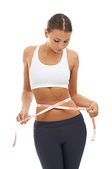 Image showing Measuring tape, results and woman check to lose weight in studio or white background. Fitness, progress and person reading measurement and size of body for health, wellness and goals from diet