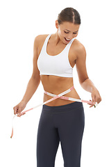 Image showing Woman, lose weight and happy with results on measuring tape in studio or white background. Fitness, check and person reading measurement and size of body for health, wellness and progress in goals