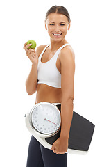 Image showing Studio portrait, apple or happy woman with scale to track weight loss progress, nutrition or body goals. Fruit, vegan lifestyle or nutritionist smile for slimming, diet or fitness on white background