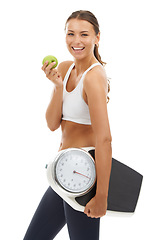 Image showing Portrait, happiness or woman with apple, scale and smile for weight loss, nutrition or body goals. Studio, healthy lifestyle or model happy for fruit benefit, diet food or fitness on white background