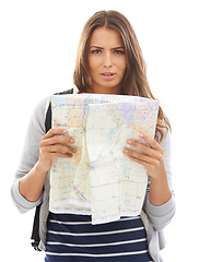 Image showing Map, confused and woman reading in studio for hiking adventure, weekend trip or vacation. Travel, discover and portrait of person with paper directions for tourism and navigation by white background.