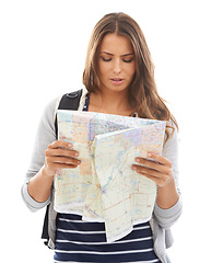 Image showing Map, explore and woman reading in studio for hiking adventure, weekend trip or vacation. Travel, discover and young female person with paper directions for tourism and navigation by white background.