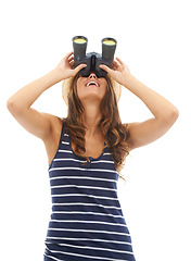 Image showing Happy, travel and woman looking up with binoculars to watch on vacation, holiday or adventure. Vision, glass and person with telescope, search to spy and excited isolated on a white studio background