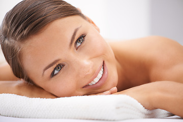 Image showing Relax, smile and young woman at spa with body massage for health, wellness and self care. Happy, natural and female person with calm, peaceful and serene skin therapy treatment at beauty salon.