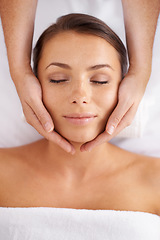 Image showing Woman, facial and massage at spa from above for beauty, skincare treatment and healing at cosmetics salon. Face of calm client relax at wellness resort for reiki, break and peaceful holistic therapy