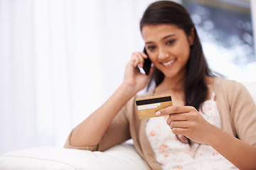 Image showing Happy woman, phone call and credit card for banking, online shopping or payment on sofa at home. Female person talking on mobile smartphone with smile for ecommerce, debit or conversation on account