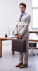 Image showing Portrait of businessman in workplace tied up in rope with depression, control and sad in law firm. Serious attorney, lawyer or legal consultant bound in office, corporate hostage with bag and stress.