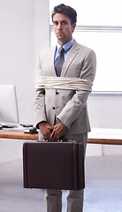 Image showing Portrait of businessman in office tied up in rope with depression, control and fear in law firm. Serious attorney, lawyer or legal consultant bound at work, corporate hostage with bag and stress.