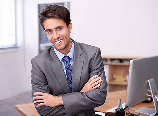 Image showing Portrait of happy businessman at desk with smile, arms crossed and career in legal inspection at law firm. Confident attorney, lawyer or business man with office job as quality assurance professional