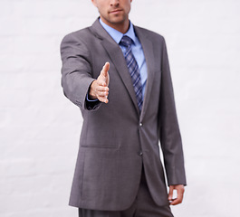 Image showing Business man, handshake and introduction for interview, agreement or welcome to deal, success and thank you. Professional or corporate person shaking hands for partnership on a white wall background