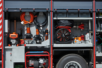 Image showing Close-up of essential firefighting equipment on a modern firetruck, showcasing tools and gear ready for emergency response to hazardous fire situations