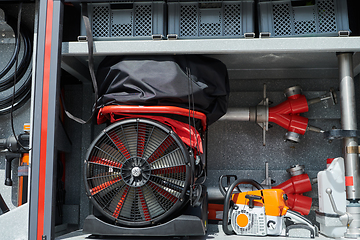 Image showing Close-up of essential firefighting equipment on a modern firetruck, showcasing tools and gear ready for emergency response to hazardous fire situations