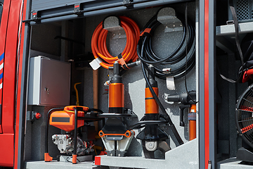 Image showing Close-up of essential firefighting equipment on a modern firetruck, showcasing tools and gear ready for emergency response to hazardous fire situations