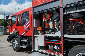 Image showing Close-up of essential firefighting equipment on a modern firetruck, showcasing tools and gear ready for emergency response to hazardous fire situations