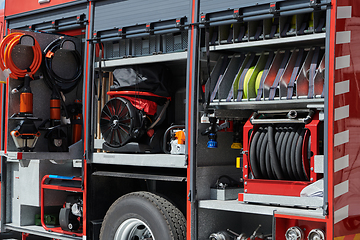 Image showing Close-up of essential firefighting equipment on a modern firetruck, showcasing tools and gear ready for emergency response to hazardous fire situations