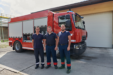 Image showing A skilled and dedicated professional firefighting team proudly poses in front of their state of the art firetruck, showcasing their modern equipment and commitment to ensuring public safety.