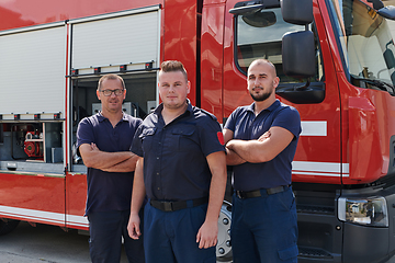 Image showing A skilled and dedicated professional firefighting team proudly poses in front of their state of the art firetruck, showcasing their modern equipment and commitment to ensuring public safety.