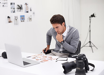 Image showing Photographer, editing and thinking with computer in office with working with technology in process. Professional, editor and creative person with laptop and photoshoot results of cinematography