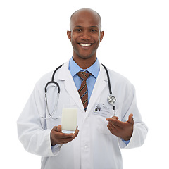 Image showing Portrait, black man and happy doctor point at milk for healthy bones, studio nutrition or calcium benefits. Beverage glass, hydration drink or African dietician with dairy product on white background