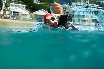 Image showing Swimming, crawl and person in ocean water in summer for exercise, training or workout on mockup space. Sea, sport and an athlete stroke outdoor for fitness, health and triathlon competition in nature