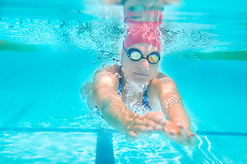 Image showing Sports, underwater or woman in swimming pool for competition training, workout or energy. Fitness, female swimmer and fast athlete diving for cardio exercise, championship and race practice at gala