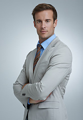 Image showing Portrait, serious and business man with arms crossed for pride in corporate career. Face, confident professional lawyer and attorney working in a suit isolated on gray studio background in Australia