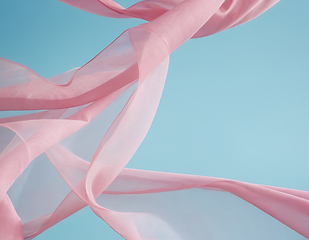 Image showing Flying pink fabric wave on blue background, flowing waving silk 