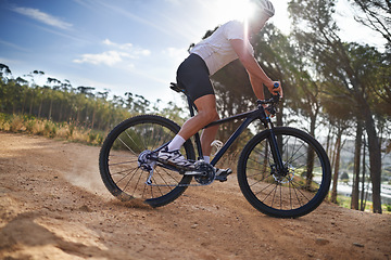 Image showing Man, cyclist and bicycle on mountain, exercise and training with energy, bike and cycling sport. Outdoor, hobby and fitness in nature, trail and active for wellness, helmet and physical workout