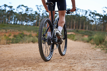 Image showing Person, legs and mountain bike for cycling adventure on nature path for healthy challenge, performance or extreme sport. Athlete, clip on cycle shoes and off road dirt terrain, speed or back view