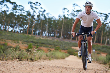 Image showing Man, mountain bike and cycling in forest for fitness sports or outdoor, exercise or athlete. Male person, transportation and off road terrain for countryside training or health, workout or adventure