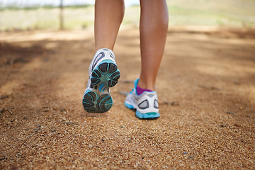 Image showing Person, feet and outdoor fitness in nature for exercise, wellness and running competition for cardio workout. Legs, training sneakers and jog in countryside with sport and strong for marathon in park