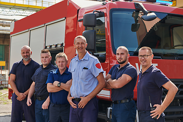 Image showing A skilled and dedicated professional firefighting team proudly poses in front of their state of the art firetruck, showcasing their modern equipment and commitment to ensuring public safety.