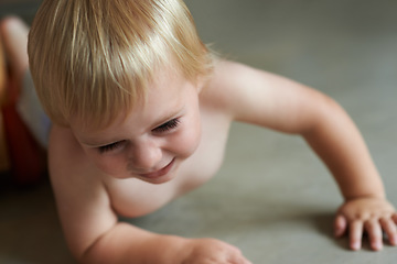 Image showing Baby, playing on floor outdoor for development with relax, curiosity and early childhood in backyard of home. Toddler, child and crawling on ground for wellness, milestone or exploring with innocence