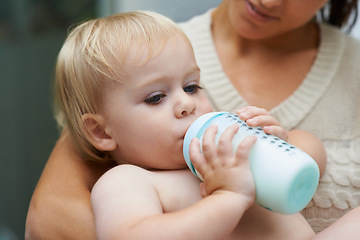 Image showing Relax, cute and baby drinking bottle and laying with mother with milk for bonding together. Growth, sweet and infant, kid or toddler enjoying a beverage for nutrition, health and child development.