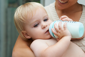 Image showing Relax, sweet and baby drinking bottle and laying with mother for milk and bonding together. Cute, growth and infant, kid or toddler enjoying a beverage for nutrition, health and child development.