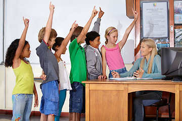 Image showing Teacher woman, classroom and children with raised hand for question, answer or pop quiz for knowledge. Teaching person, school kids and education for development, scholarship or assessment at academy
