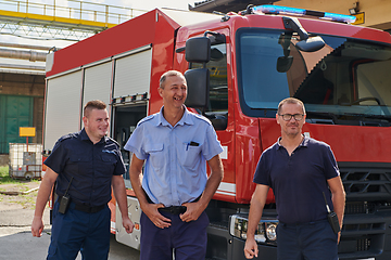 Image showing A skilled and dedicated professional firefighting team proudly poses in front of their state of the art firetruck, showcasing their modern equipment and commitment to ensuring public safety.