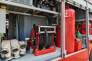 Image showing Close-up of essential firefighting equipment on a modern firetruck, showcasing tools and gear ready for emergency response to hazardous fire situations