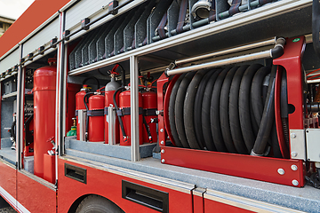 Image showing Close-up of essential firefighting equipment on a modern firetruck, showcasing tools and gear ready for emergency response to hazardous fire situations