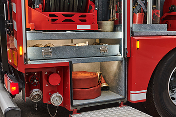 Image showing Close-up of essential firefighting equipment on a modern firetruck, showcasing tools and gear ready for emergency response to hazardous fire situations