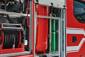 Image showing Close-up of essential firefighting equipment on a modern firetruck, showcasing tools and gear ready for emergency response to hazardous fire situations