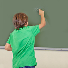 Image showing Boy, chalkboard and school writing with kid education, cursive and answer for learning. Back, knowledge and student development in a study lesson with child in classroom with chalk and solution