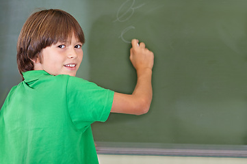 Image showing Writing, chalkboard and portrait of kid at school with education and answer for learning. Drawing, knowledge and youth development in study lesson with boy in classroom with chalk and solution