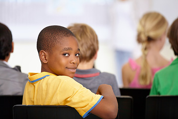 Image showing Portrait, black boy or student in classroom for knowledge, education or development for future growth. Scholarship, back to school or happy child in chair for studying, listening or learning at desk