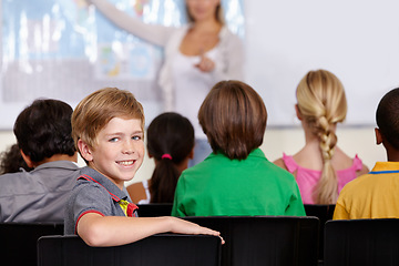 Image showing Portrait, happy boy or student in classroom for knowledge, education or development for future growth. Smile, back to school or child in chair for studying, listening or fun learning for scholarship