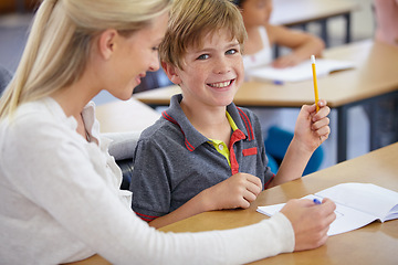 Image showing Teacher, child portrait and classroom for learning, education and writing or language development with support. Happy woman teaching, helping and face of student with knowledge or questions at school