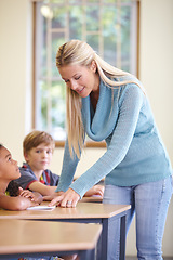 Image showing Teacher, kids and students in classroom for education, learning and writing or language development with support. Happy woman and children for teaching, helping with knowledge and questions at school