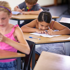 Image showing Children, classroom and girl writing test, learning and knowledge with exams, school and thinking. Ideas, kids and child development with a book, students and education with information and decision