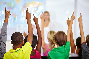 Image showing Back of students, classroom and raise hands for questions, education or learning with geography quiz in school. Youth, group or smart kids with teaching for support, class ideas and answer or advice